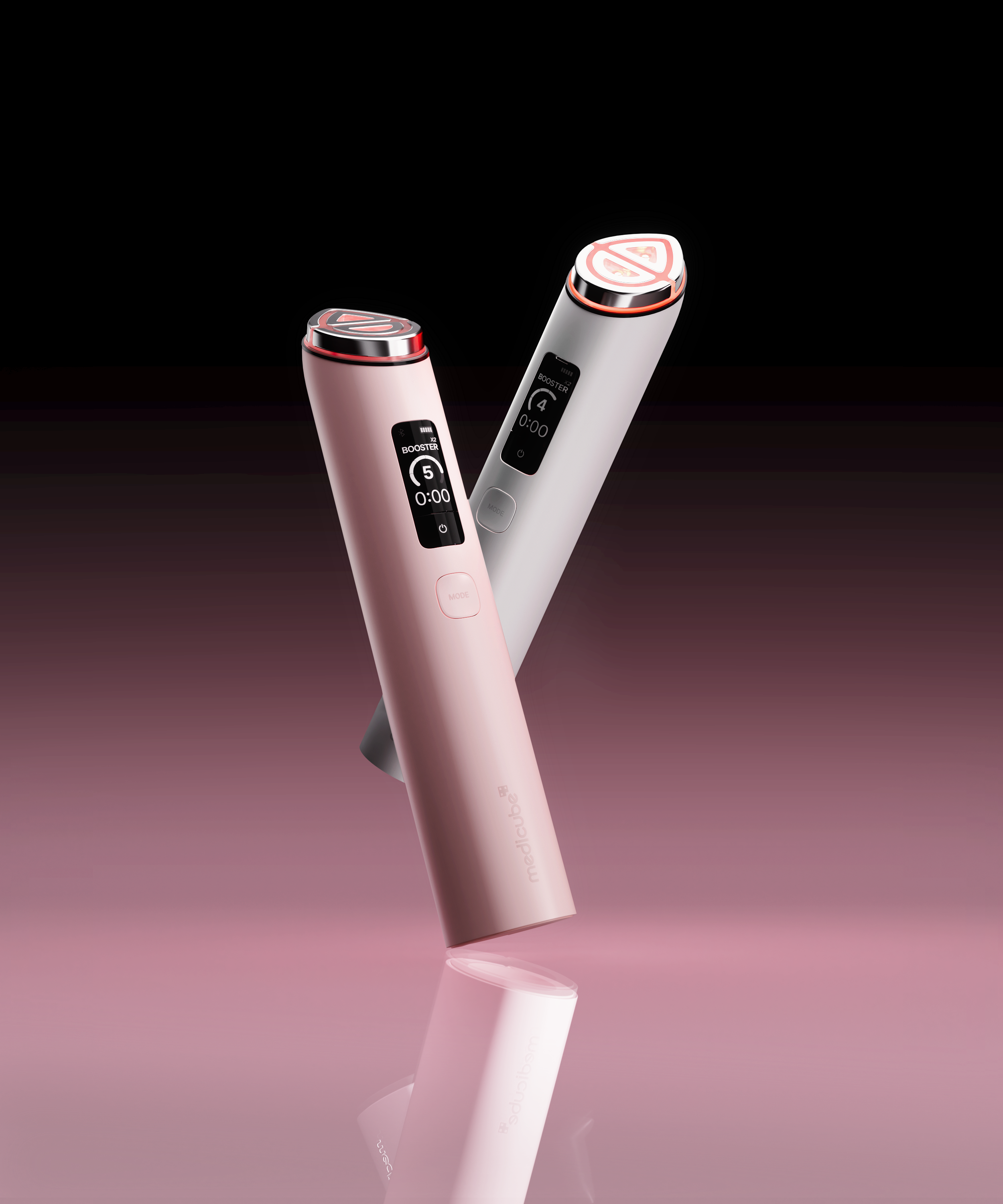 two skincare devices, one white and one pink, on a purple ombre background