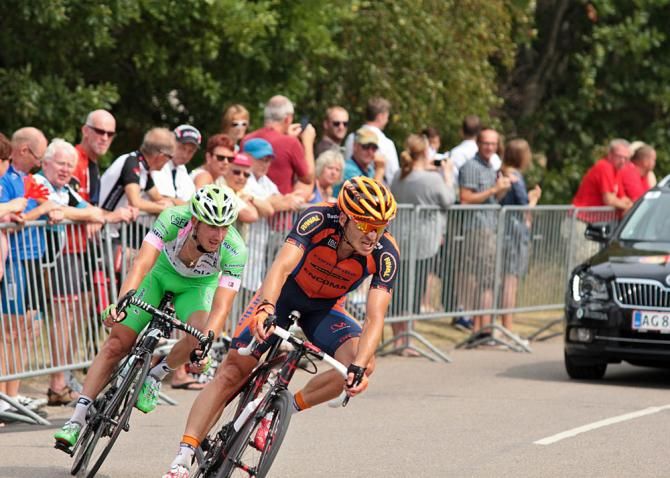 Two riders take a corner at high speed