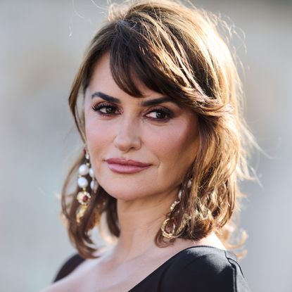 a close up photo of a middle-aged woman with shoulder-length brown hair