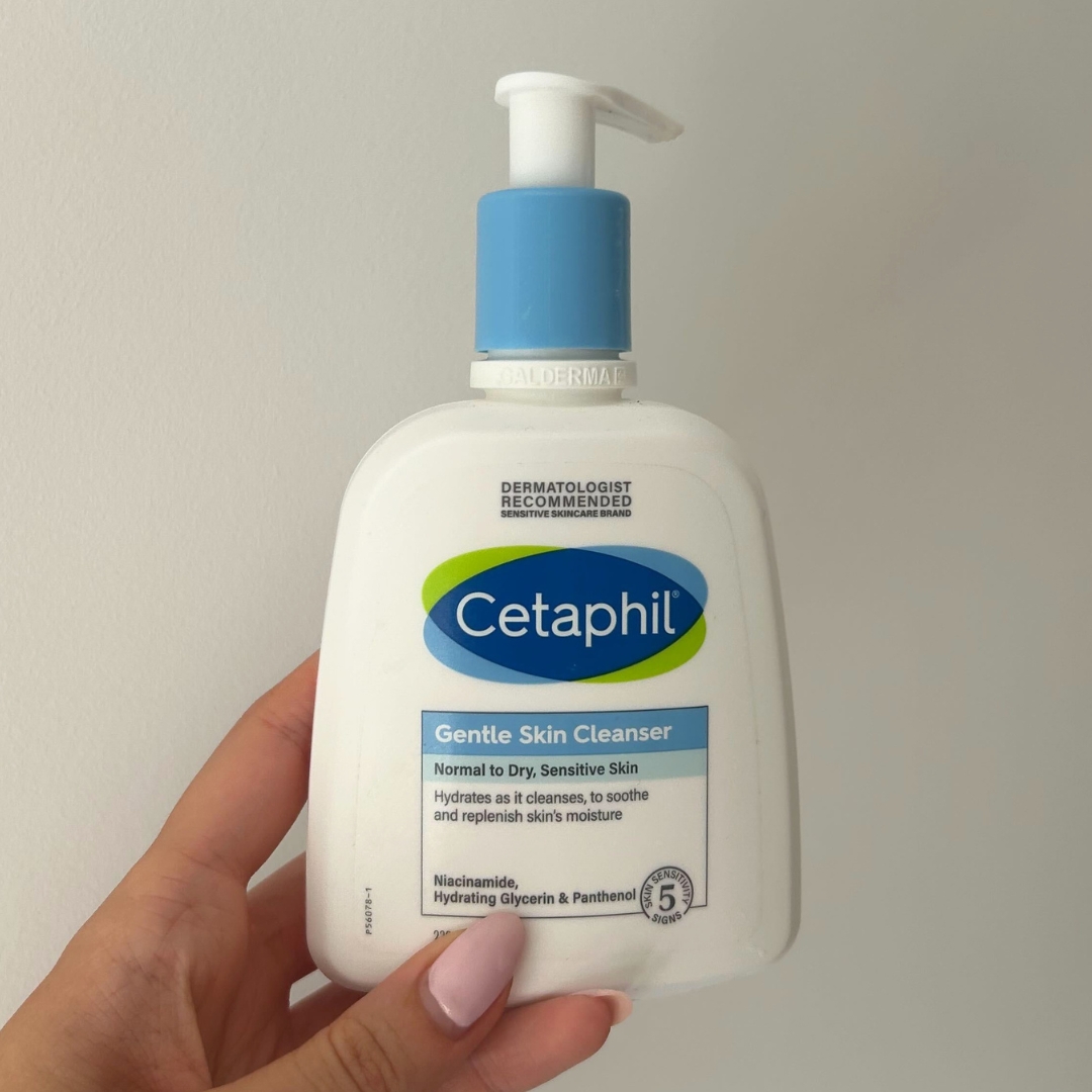 Hand holding empty bottle of Cetaphil Gentle Skin Cleanser