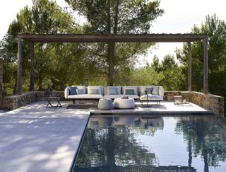 pool surrounding by concrete paving with modern furniture from Go Modern
