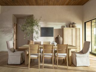 A neutral dining room with a wooden dining table