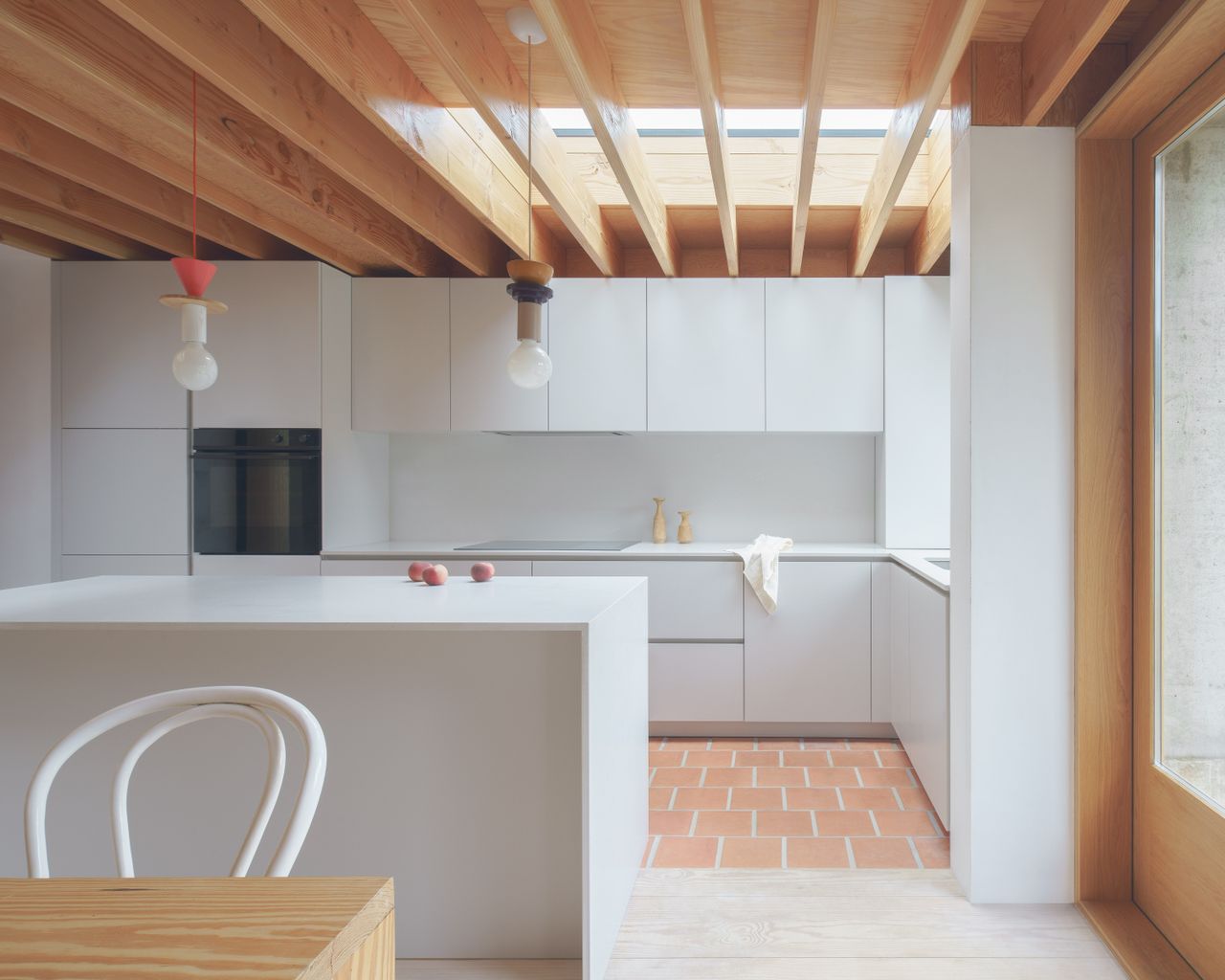 minimalist kitchen with modern white cabinets and pine beams 