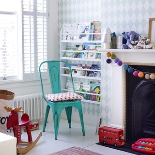 childrens room with blue wallpaper and book storage