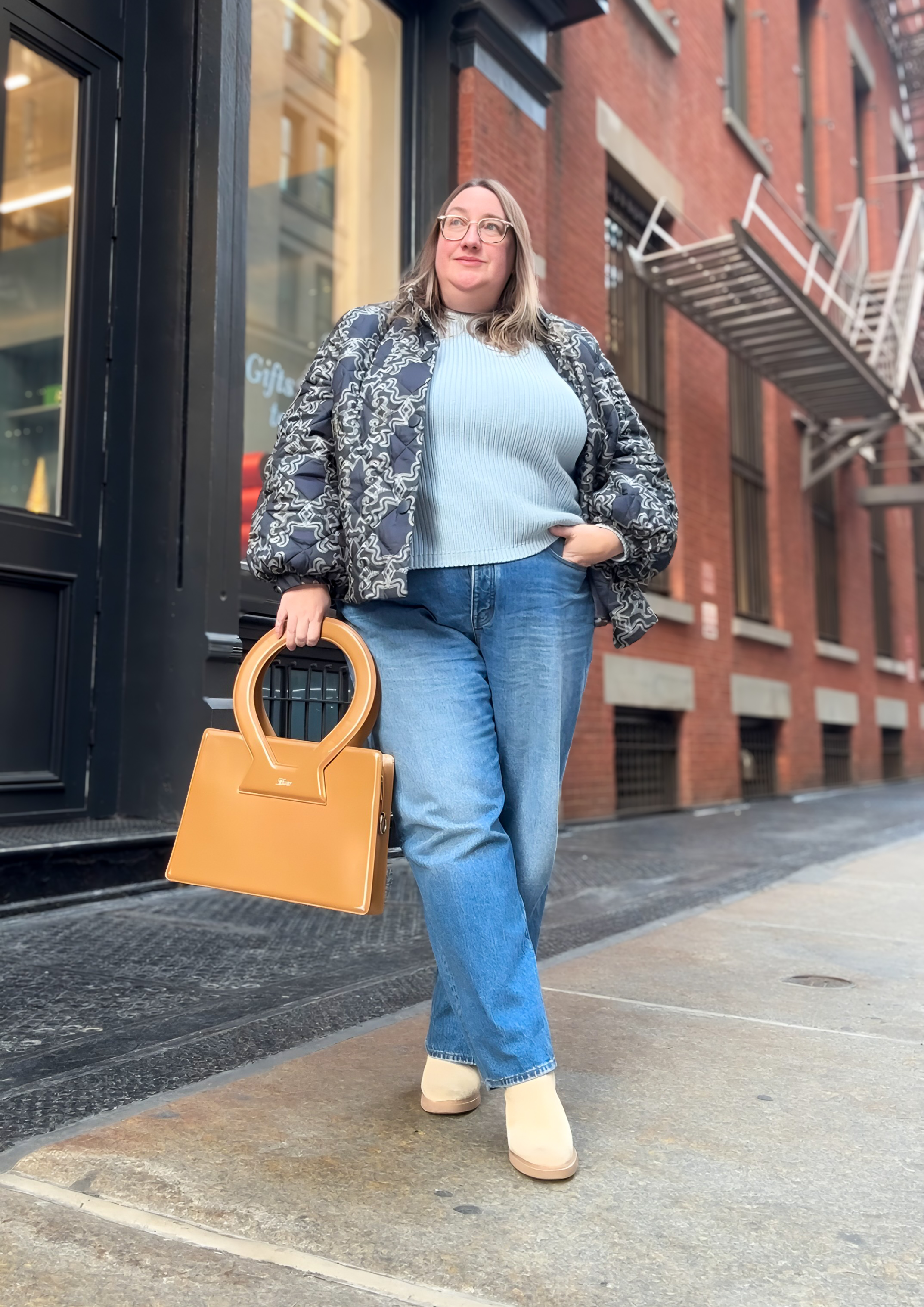 Sarah Chiwaya wearing a Quince sweater with jeans