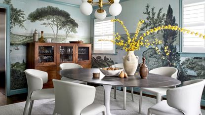 dining room with tree mural and white dining chairs with yellow blossom
