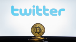 The Twitter logo in the background of a a coin representing the physical embodiment of Bitcoin