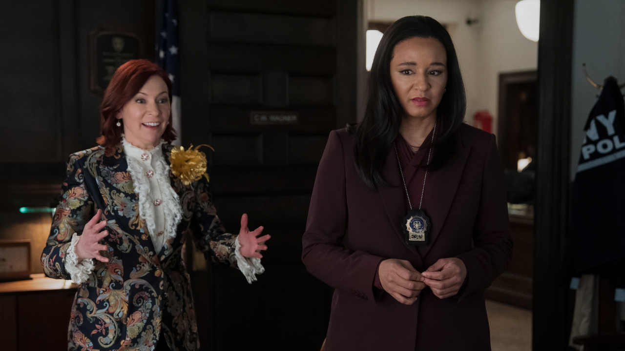 Carrie Preston as Elsbeth Tascioni with her hands out explaining something, and Carra Patterson as Kaya Blanke looking concerned.
