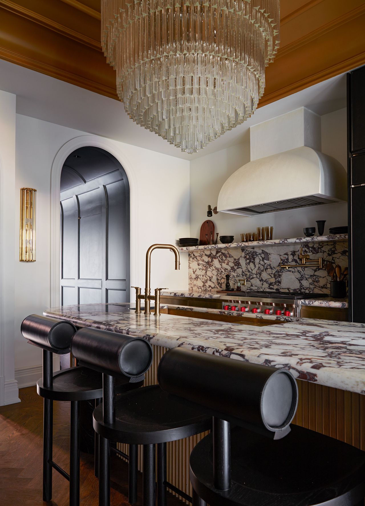 a marble kitchen with a golden painted ceiling