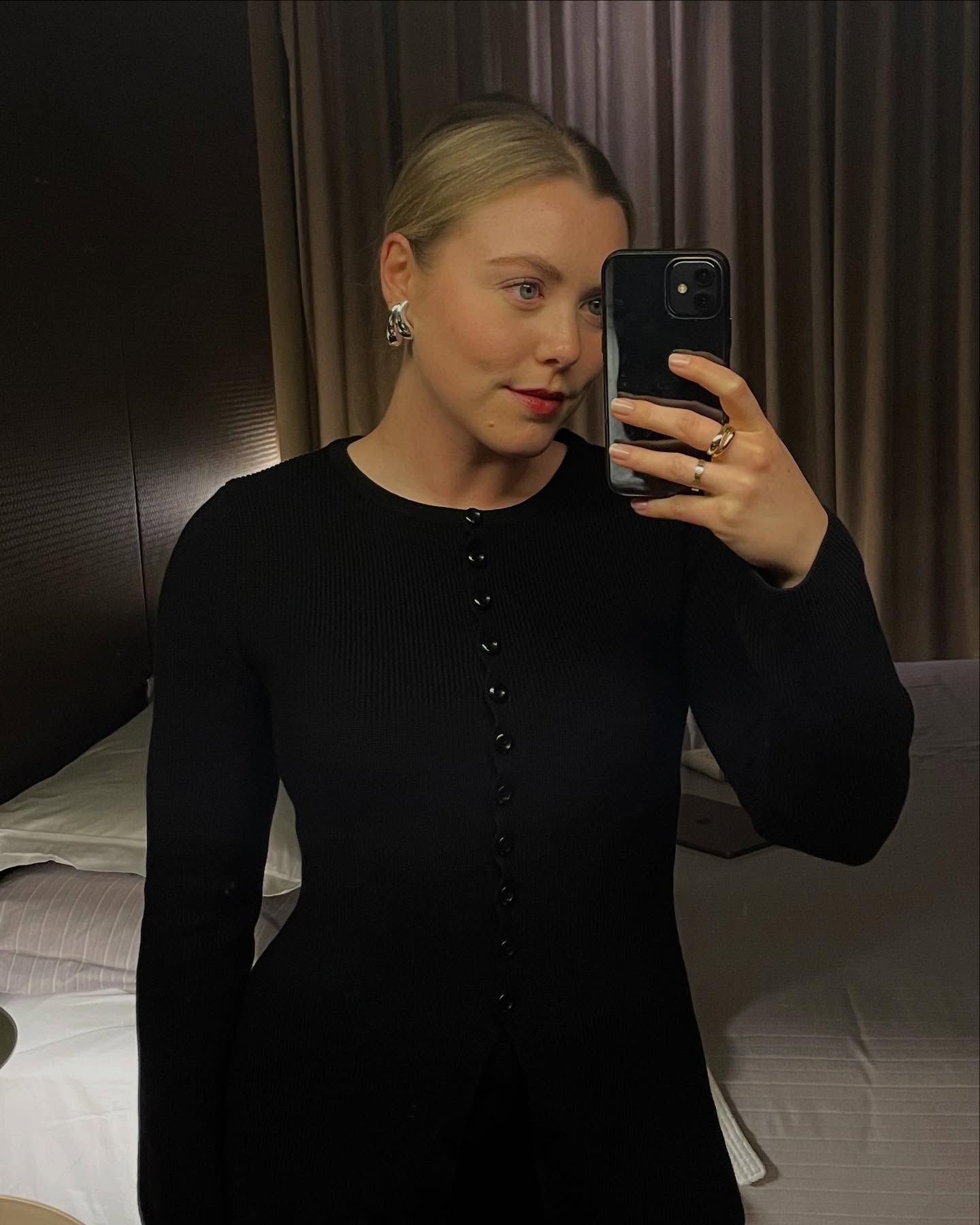 Woman wears a black cardigan