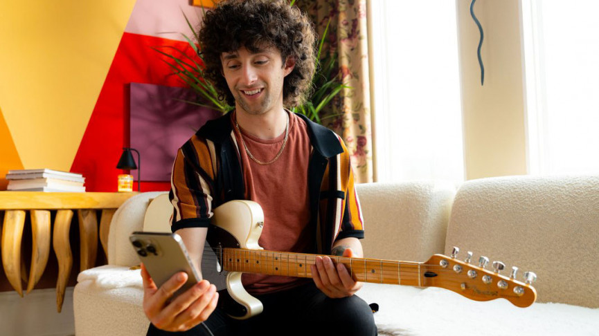 A long haired man with a guitar