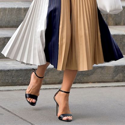 A close up of Victoria Beckham's feet in high heeled sandals that show her bunions