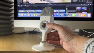 simorr Wave U1, one of the best budget mics, being held in front of a laptop