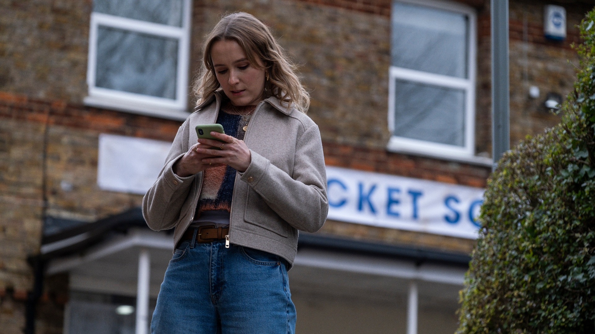 Alison texts on her phone in Code of Silence