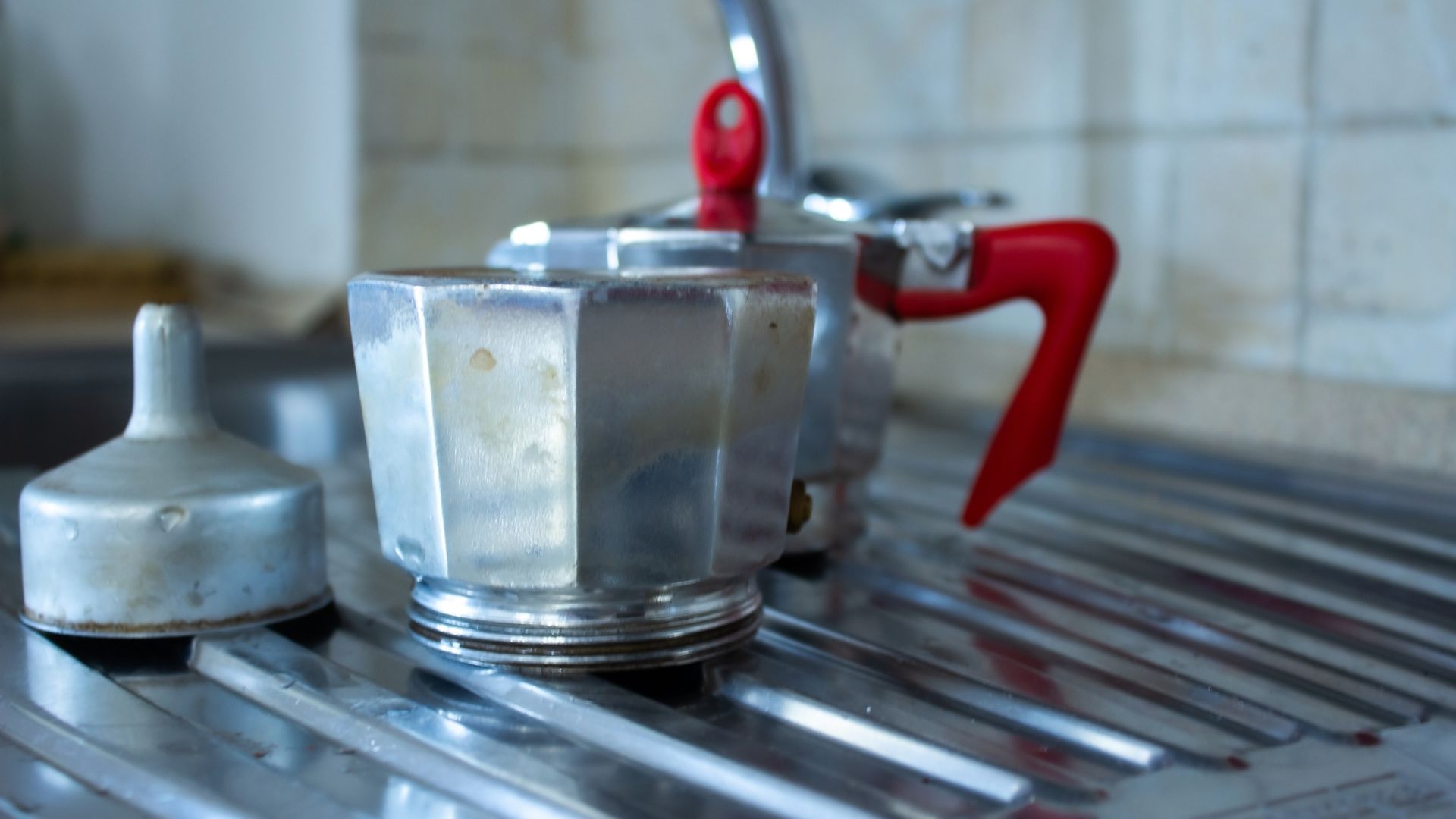 picture of moka pot disassembled drying on drying rack