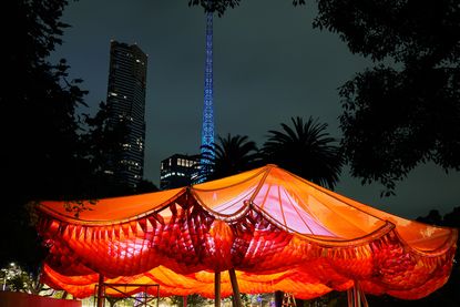 Mpavilion 2022 opens, showing here orange canopy structure at night