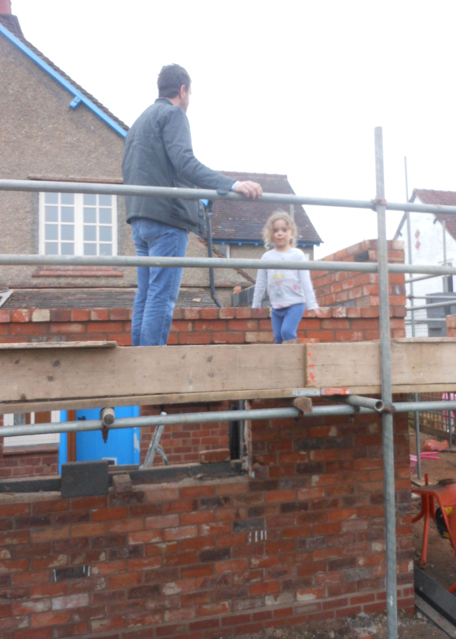 man and child standing on scaffolding