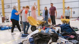 The Appleyards filling wheelbarrows with belongings.