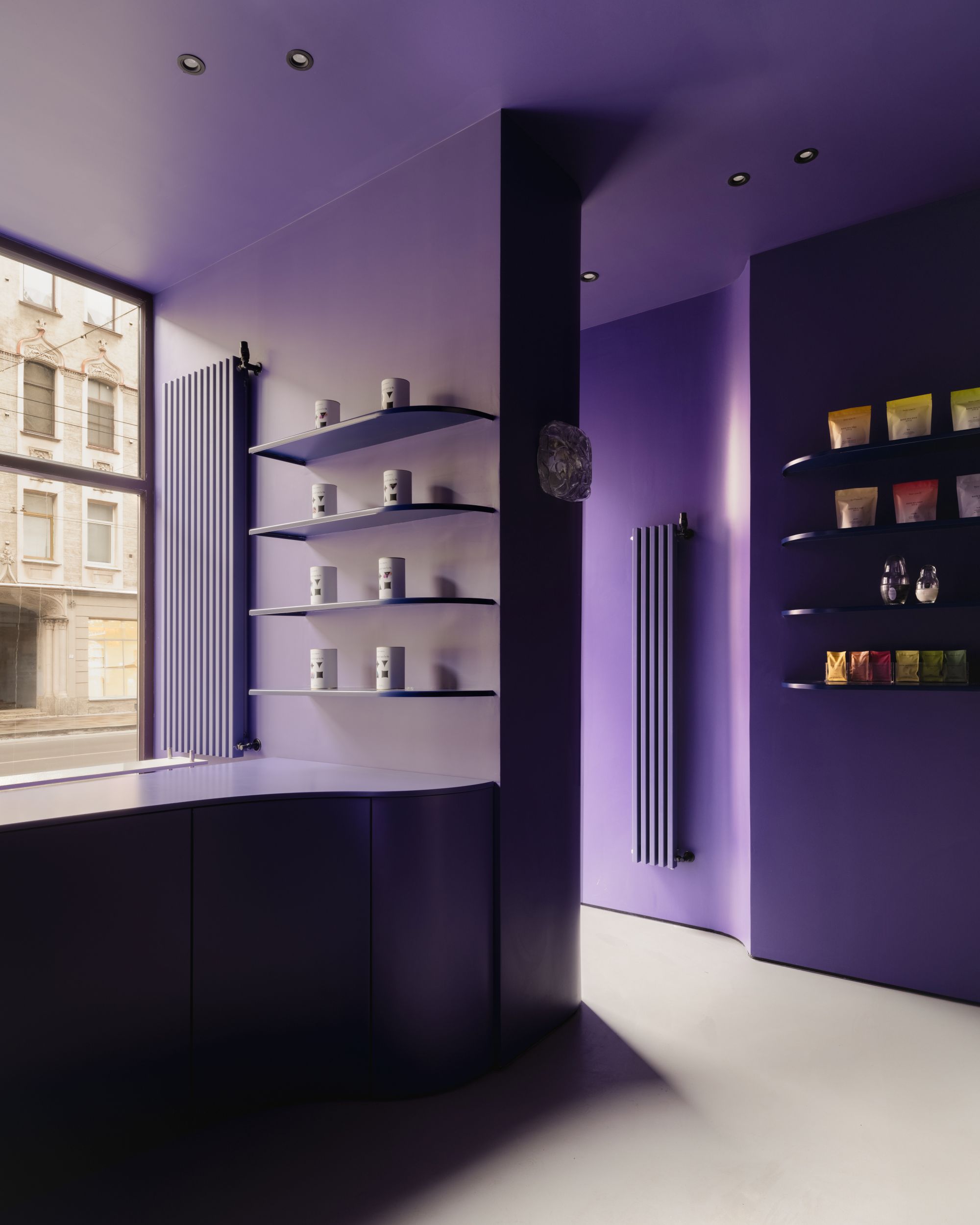 a purple space with shelving on the walls and a white floor