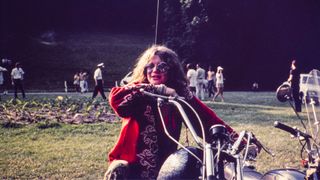 Janis Joplin sitting on a motorcycle