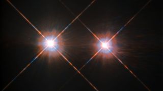 The binary stars of the nearby Alpha Centauri system, as seen by NASA's Hubble Space Telescope. On the left is Alpha Centauri A, which is a sun-like G-type star. On the right is Alpha Centauri B, which is a slightly cooler K-type star.