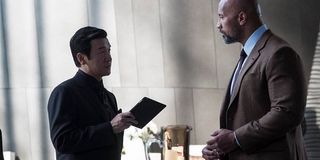 Chin Han with Tablet talking to Dwayne Johnson in Skyscraper