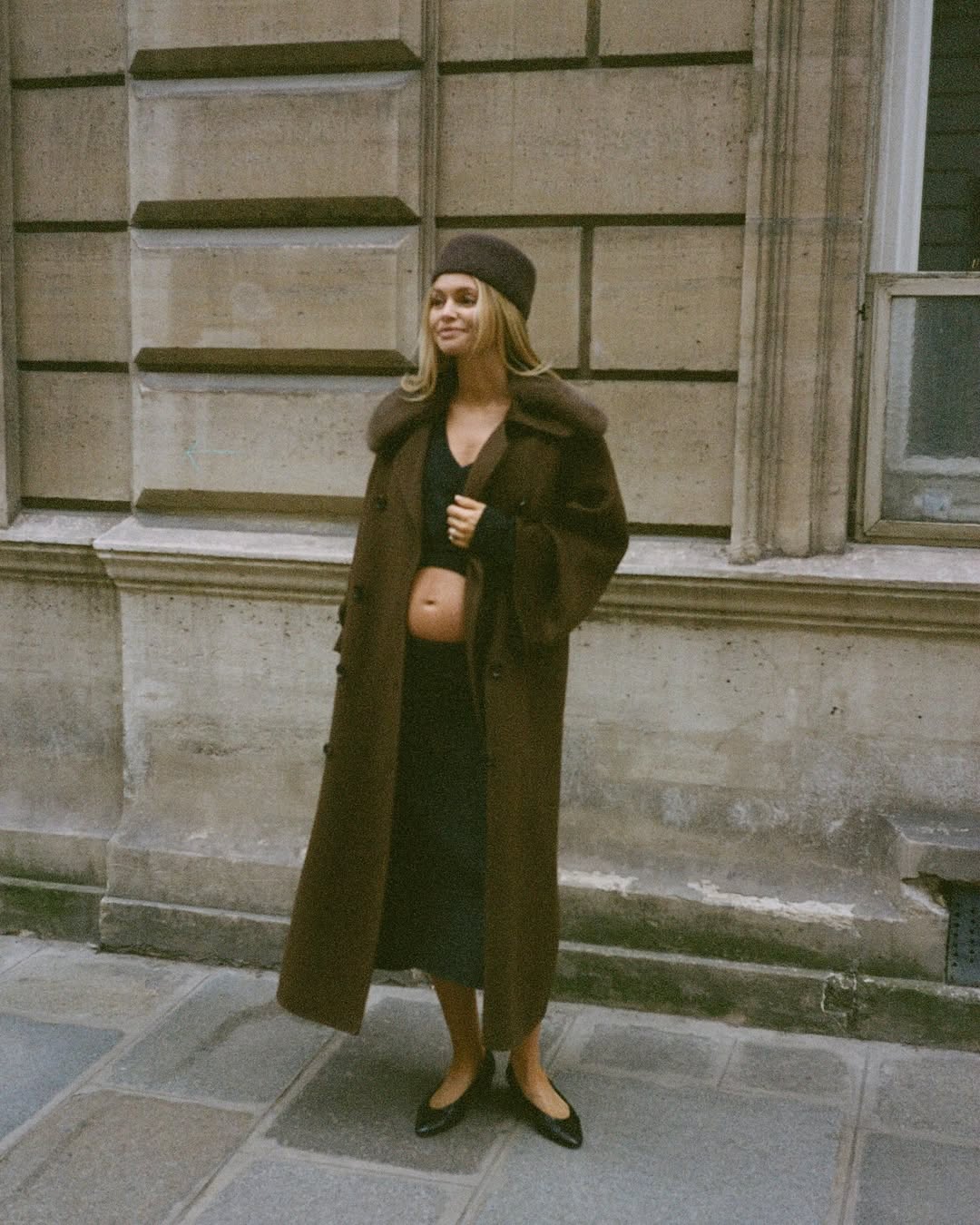 claire rose cliteur wears a coat and black two-piece set