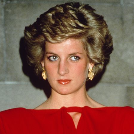 Princess Diana wearing a red off the shoulder dress and with blonde bouffant hair at a state reception in Melbourne, October 1988