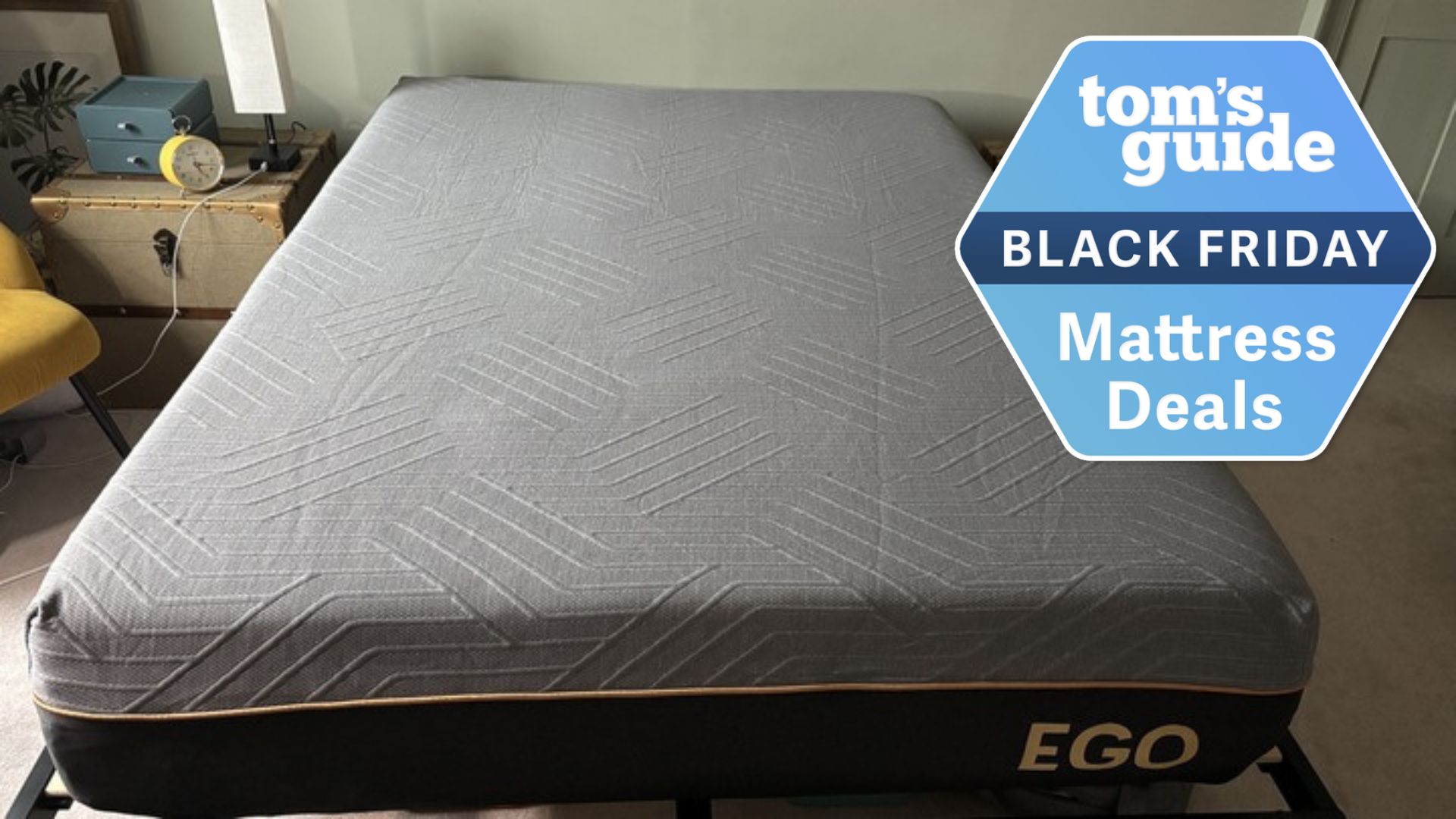 An image of a full-size EGOHOME Black 12" Memory Foam Mattress in a testers bedroom. A Black Friday deals badge is seen in the top left foreground.