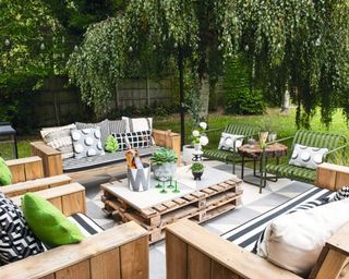 A stylish patio area with seating decor and DIY pallet coffee table