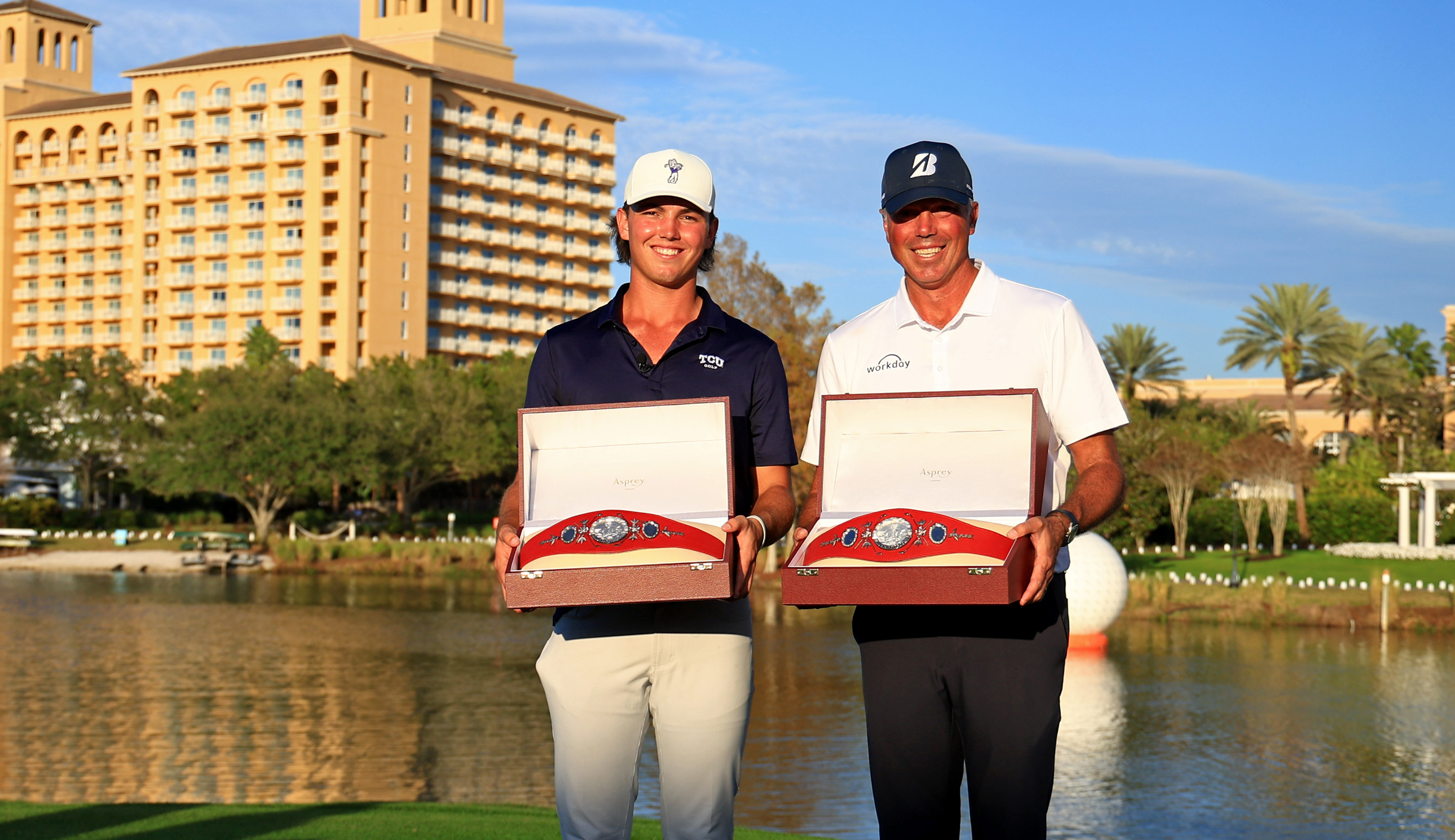Cameron and Matt Kuchar pose with the PNC Championship belts