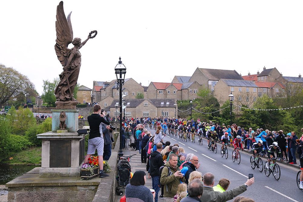 The peloton goes over Wetherby Bridge during stage 2 at Tour de Yorkshire