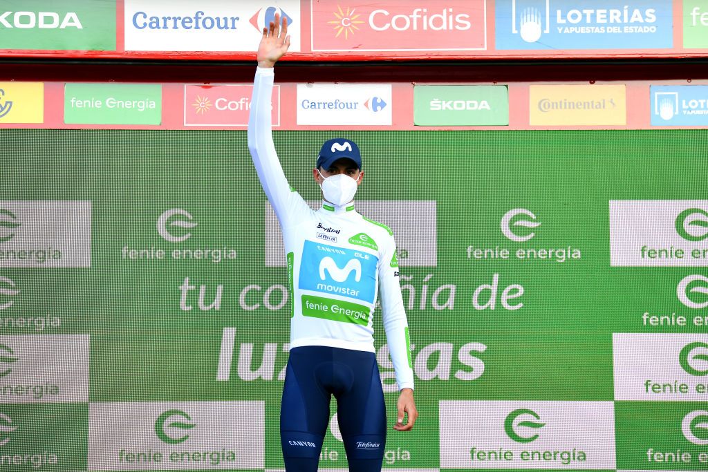 SUANCES SPAIN OCTOBER 30 Podium Enric Mas Nicolau of Spain and Movistar Team White Best Young Jersey Celebration Mask Covid safety measures during the 75th Tour of Spain 2020 Stage 10 a 185km stage from Castro Urdiales to Suances lavuelta LaVuelta20 La Vuelta on October 30 2020 in Suances Spain Photo by Justin SetterfieldGetty Images