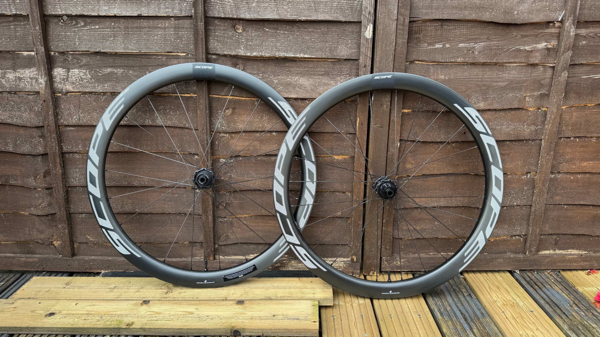 Scope R4.A wheelset leaning up against a fence