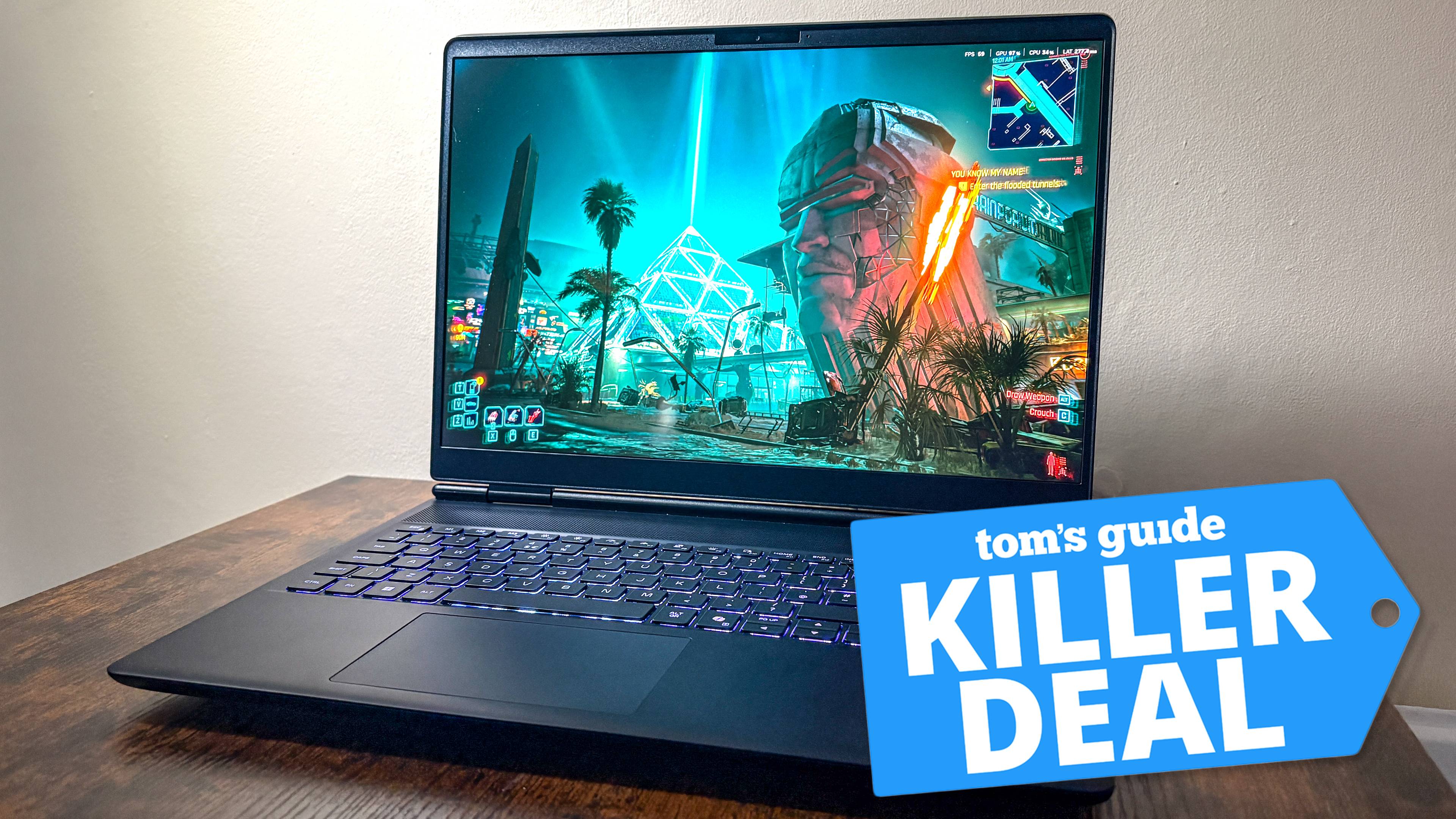 Alienware laptop on table with Cyberpunk 2077 on display with Tom's Guide Killer Deal badge