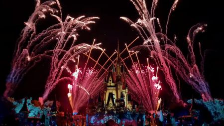 Fireworks exploding over the castle at Disney World at night