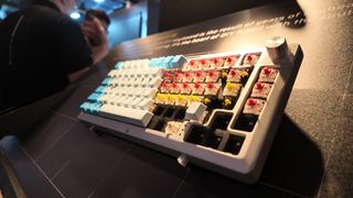 Corsair's MAKR 75 as seen on the showfloor at Computex 2025. Some of the keycaps have been removed to expose the Corsair switches underneath. The customisable keyboard has the rotary dial module installed in the top right-hand corner of the keyboard.