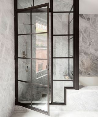 Marble bathroom with steel-framed door