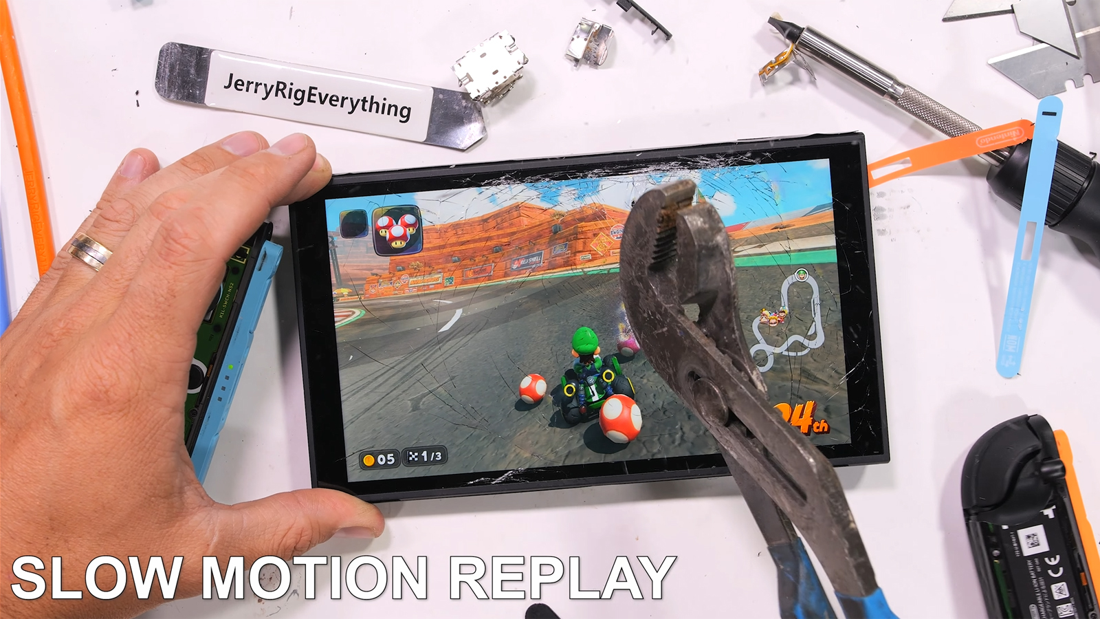 JerryRigEverything breaking the Nintendo Switch 2 screen with a pair of pliers