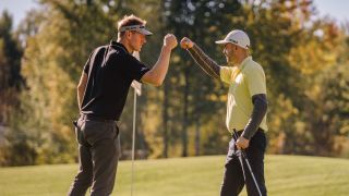 Golfers fist bumping