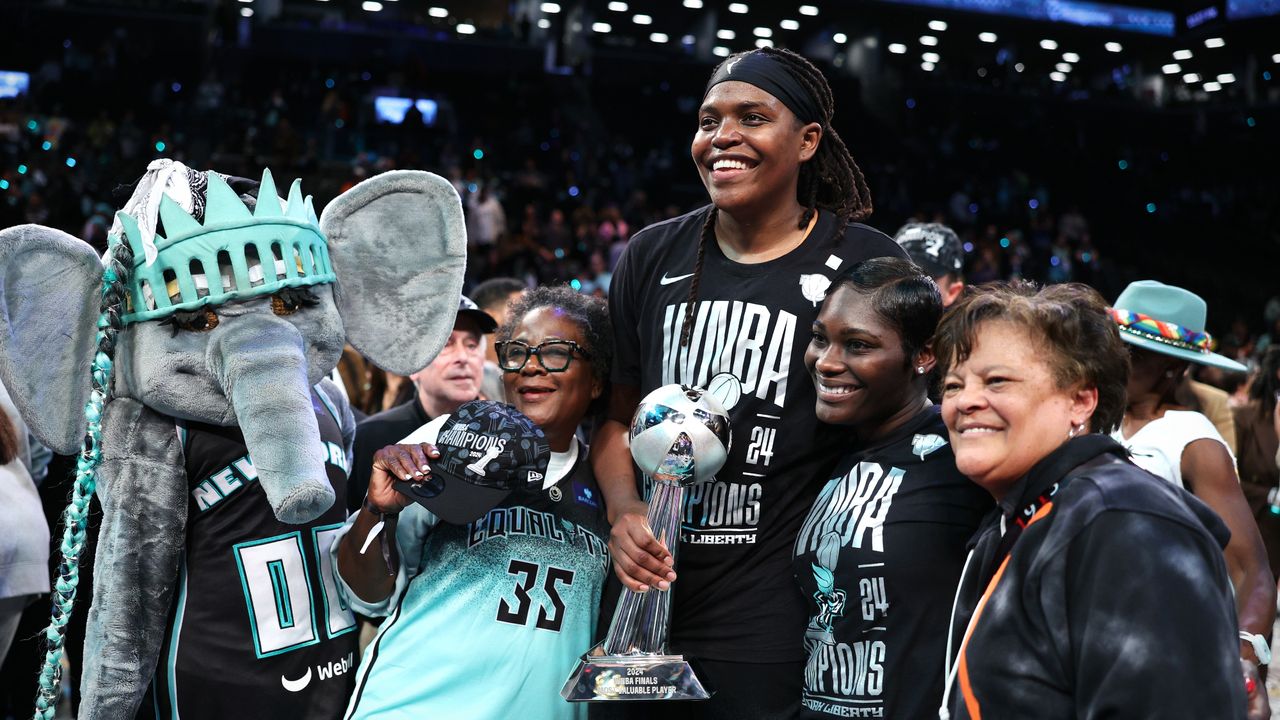 Jonquel Jones of the New York Liberty holds WNBA championship trophy