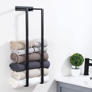 Black towel rack with rolled towels