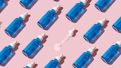 Blue glass vials on pink background with dropper