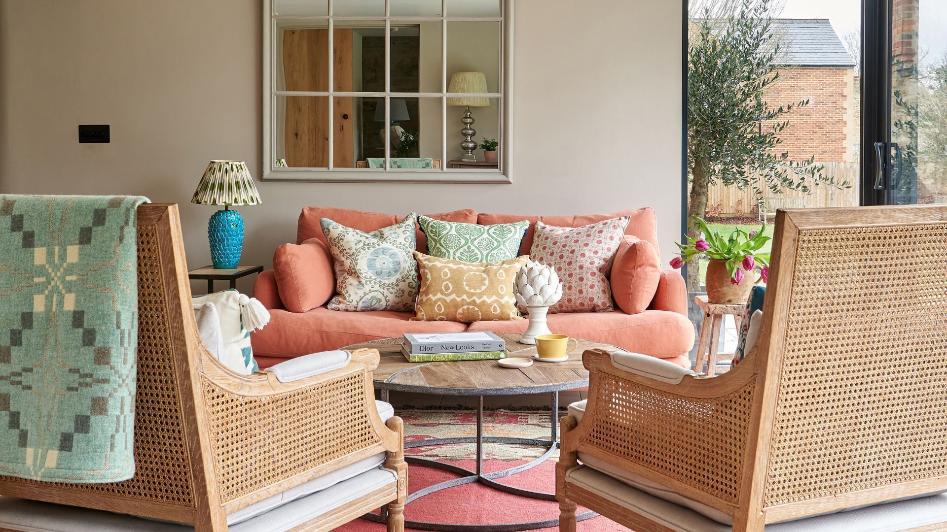 A neutral sitting room with orange sofa