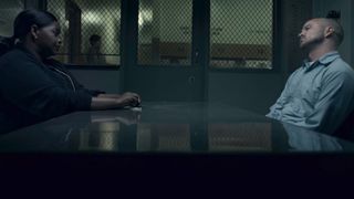L to R: Octavia Spencer and Aaron Paul sitting across the interrogation table from each other in Truth Be Told