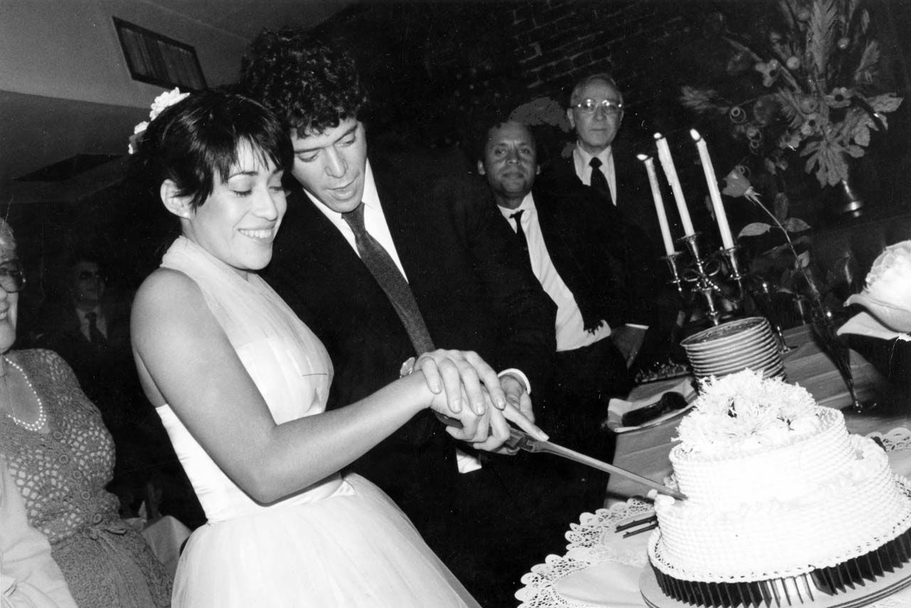 Lou Reed and Sylvia Morales cutting the cake at their wedding.
