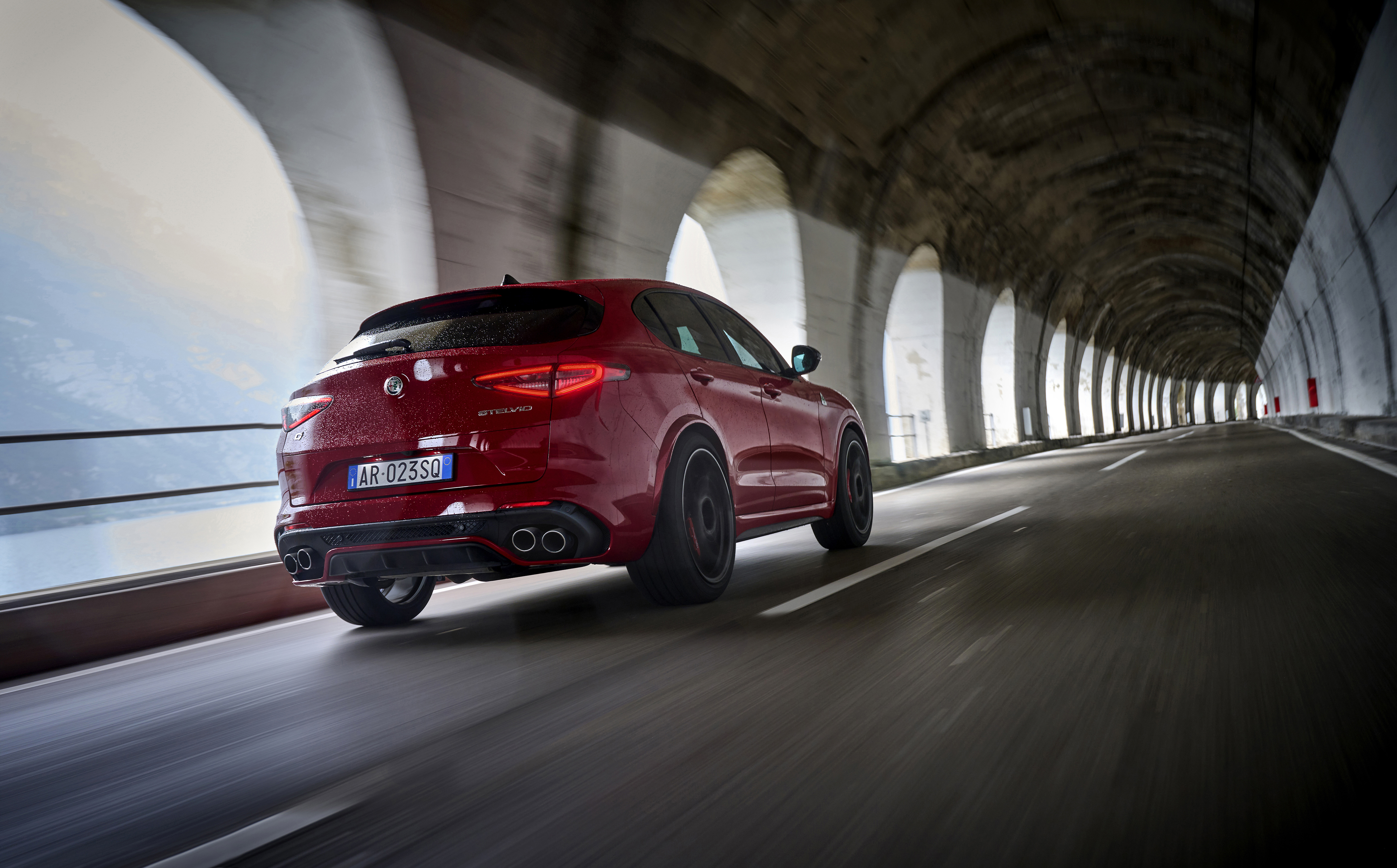 Dynamic images of a red stelvio zooming around the roads