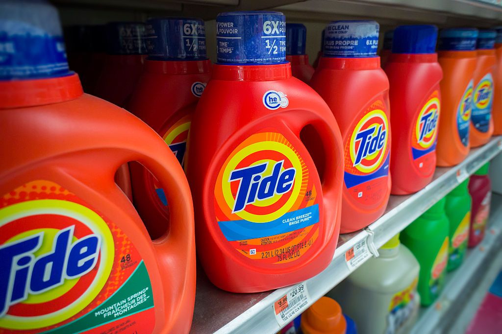 rows of Tide Detergent - a brand owned by Procter &amp; Gamble - line a store shelf