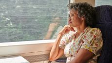 Portrait of a mature woman gazing out of train window