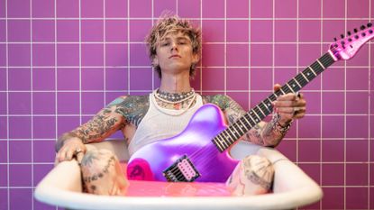 Machine Gun kelly in the MGK Hulu doc, Life in Pink, sitting in pink bathroom with guitar